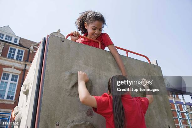 girls on a climbing wall - girl rising stock-fotos und bilder