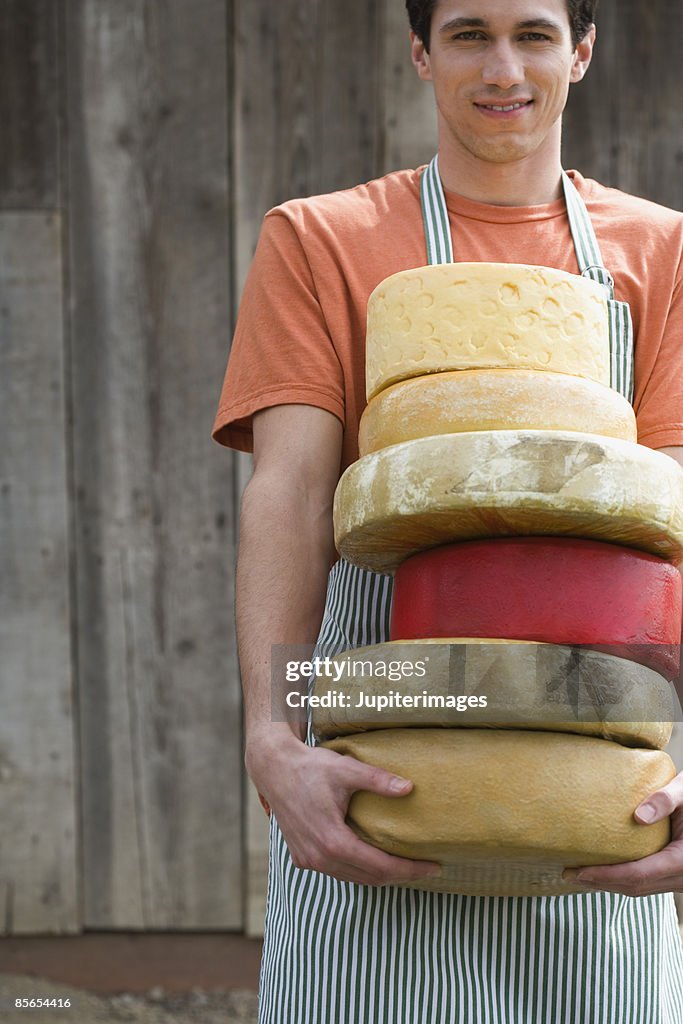 Man with cheese wheels