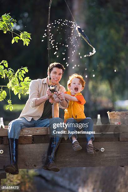 father and son fishing - catch of fish stock pictures, royalty-free photos & images