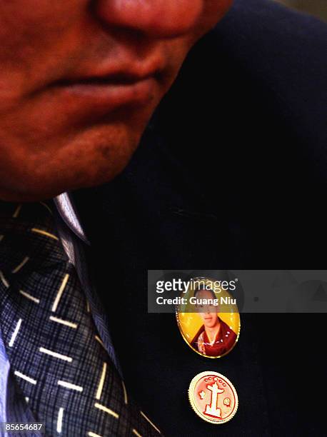 Tibetan delegate wears a badge of the Panchen Lama, Gyaltsen Norbu, during a government symposium to mark the 50th anniversary on the liberation of...