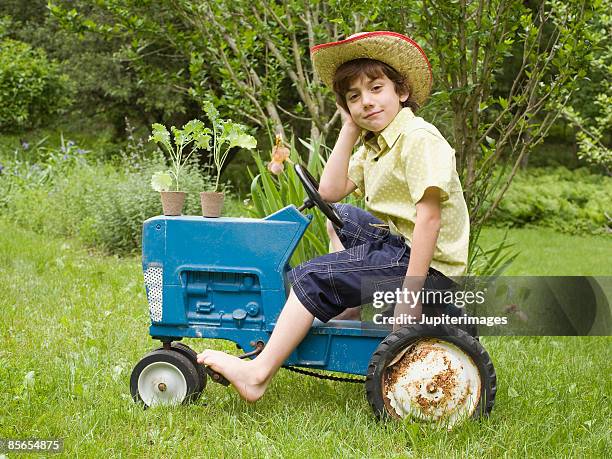 boy riding tractor - macchina a pedali foto e immagini stock