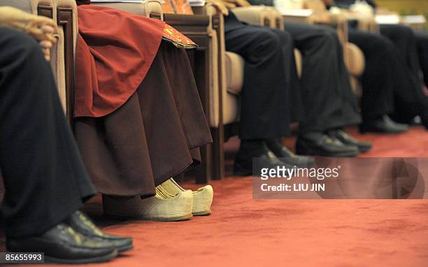 The shoes of Tibet's Panchen Lama Gyaincain Norbu are seen as he attends a symposium marking 50th anniversary on the liberation of Tibetan slaves at...