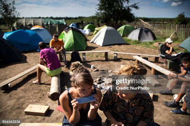 Woman plays on harmonica. &quot;Camp for Forest&quot; Pogorzelce near Bialowieza on August 15, 2017.