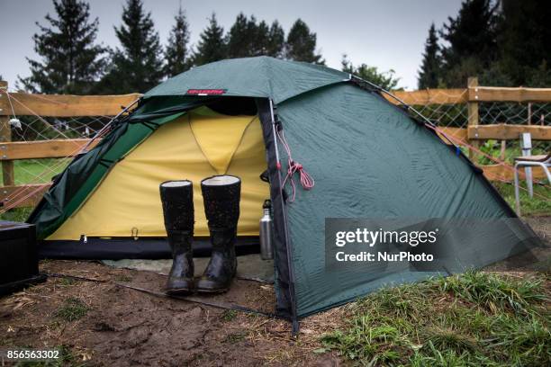 Pair of wellys near tent. &quot;Camp for Forest&quot; Pogorzelce near Bialowieza on September 21, 2017.