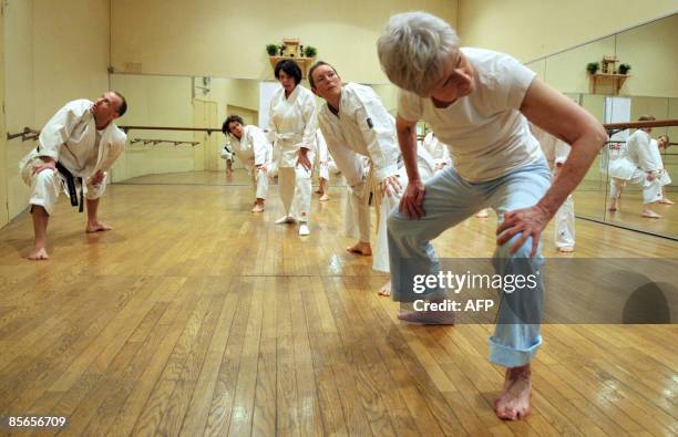 Cancer: quand le karaté aide les patients à combattre la maladie" - Karate students warm up in front of teacher Jean-Marc Descotes prior to the start...