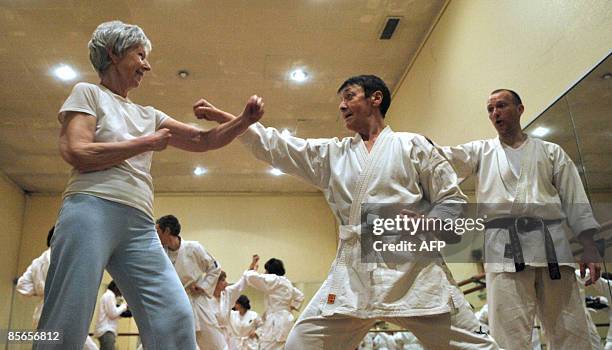 Cancer: quand le karaté aide les patients à combattre la maladie" - Karate Teacher Jean-Marc Descotes checks the position of a Karate student during...