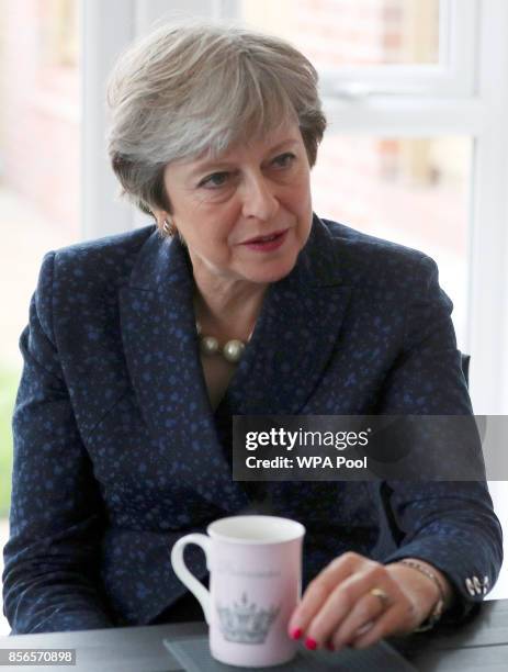 British Prime Minister Theresa May visitis a home in Walkden, near the Conservative Party's conference on October 2, 2017 in Manchester, United...