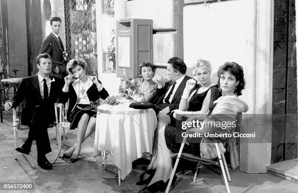 Italian film director Federico Fellini at the cocktail party for 'La Dolce Vita' in Cinecittà with actor Marcello Mastroianni , actresses Anouk...