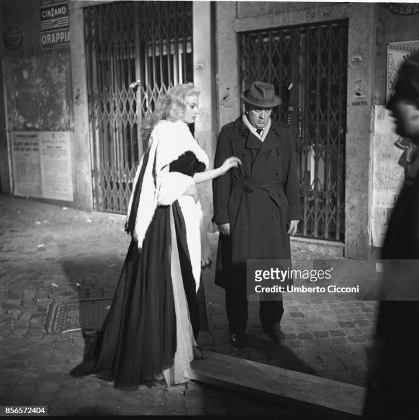 Italian film director Federico Fellini is with actress Anita Ekberg during the shooting of the movie 'La Dolce Vita'. They are close to 'Trevi...