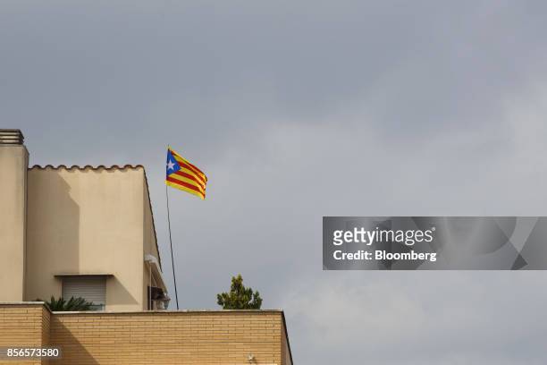 Catalan separatist flag, known as an Escalade, flies from the terrace of a residential home in Manresa, Spain, on Sunday, Oct. 1, 2017. Spanish...