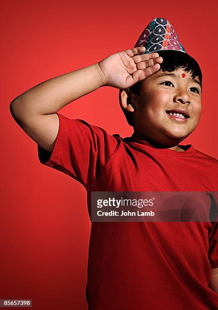 young nepali boy wearing dhaka topee. - child saluting stock pictures, royalty-free photos & images