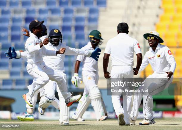 Players of Sri Lanka celebrate after dismissing Asad Shafiq of Pakistan during Day Five of the First Test between Pakistan and Sri Lanka at Sheikh...