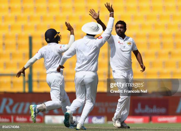 Dilruwan Perera of Sri Lanka celebrates with teammates after dismissing Babar Azam of Pakistan during Day Five of the First Test between Pakistan and...