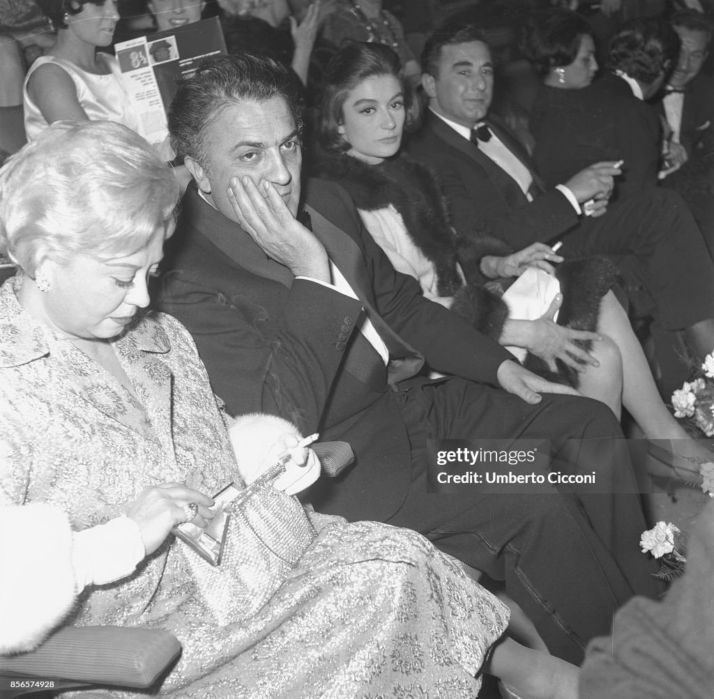 Film director Federico Fellini at the 'Cinema Fiamma' with Angelo Rizzoli (left), Giulietta Masina and Anouk Aimee in 1963