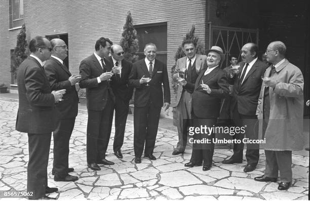 Italian film director Federico Fellini with Francesco Rosi, Walter Chiari, Achille Corona, Angelo Rizzoli and Saro Urzi at the Sala Palatino for a...