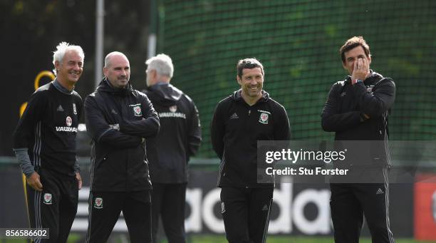 Wales coach Chris Coleman and his coaching staff share a joke with Ian Rush look on during Wwales training ahead of their World Cup Qualifiers at...