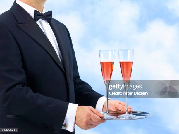 waiter, butler with two glasses of pink champagne. - silbertablett stock-fotos und bilder