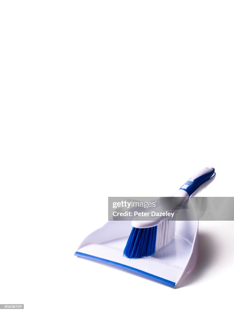 White dust pan and brush on white background.