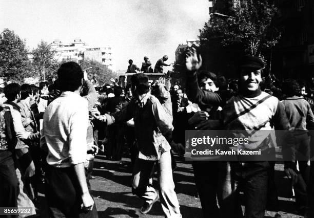 Victorious crowd with the conceding army following them in vehicles in Tehran, in the late afternoon of the day the victory of the Iranian Revolution...