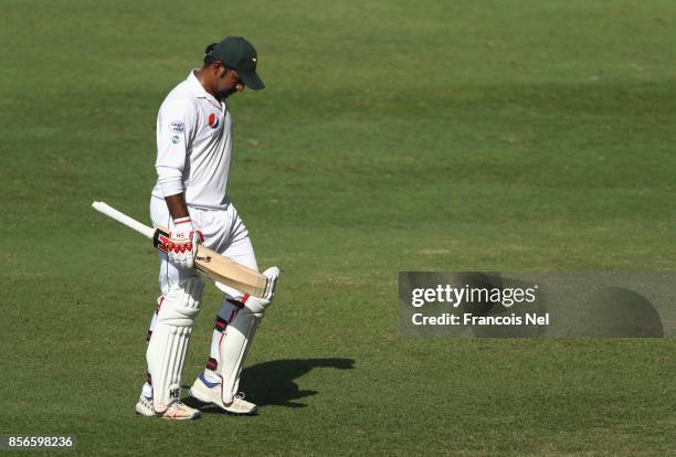 Sarfraz Ahmed of Pakistan leaves the field after being dismissed by Niroshan Dickwella of Sri Lanka during Day Five of the First Test between...