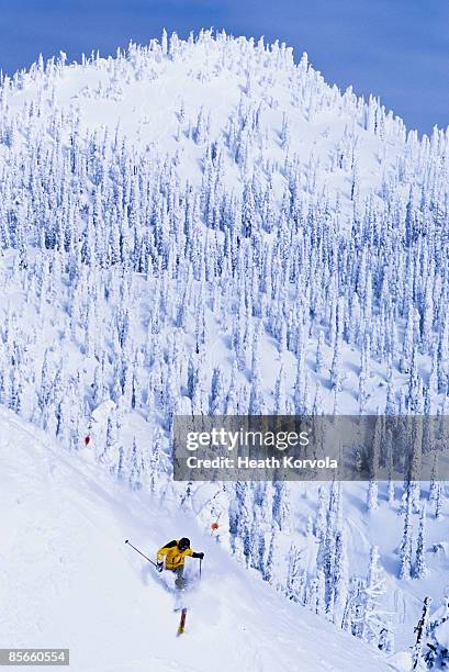 skier with big turn below peak. - whitefish foto e immagini stock