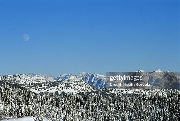 snow covered mountain and moon. - whitefish montana stock pictures, royalty-free photos & images