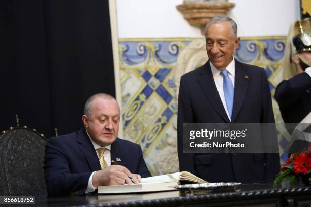 Portugal's President Marcelo Rebelo de Sousa looks on as Georgia's President Giorgi Margvelashvili signs the honor book at the Belem Palace in...