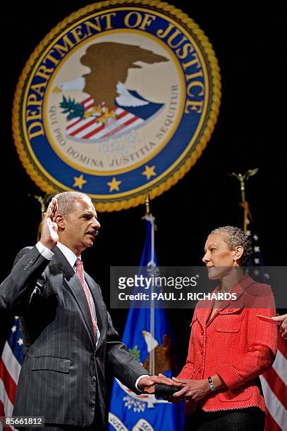 Attorney General Eric H. Holder Jr. Is sworn-in as his wife, Dr. Sharon Malone holds the Bible, during an installation ceremony as the 82nd Attorney...