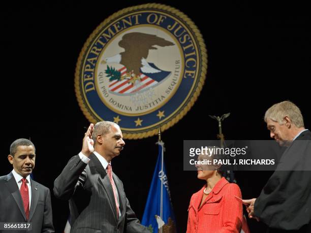 President Barack Obama listens as US Attorney General Eric H. Holder Jr. Is sworn-in, with his wife, Dr. Sharon Malone holding the Bible, as Judge...