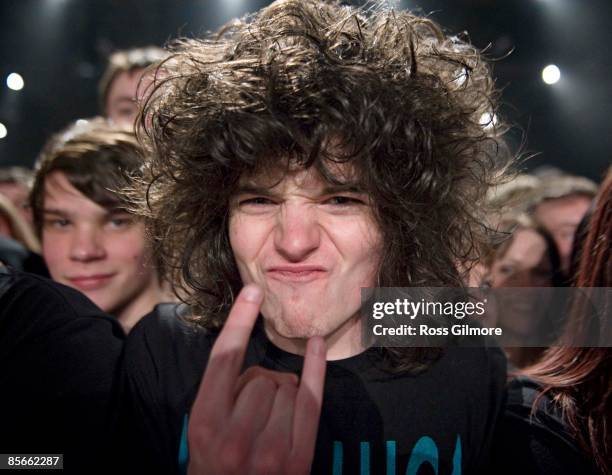 Fan in audience doing devil horn gesture while watching Metallica play at S.E.C.C. On March 26, 2009 in Glasgow, Scotland.