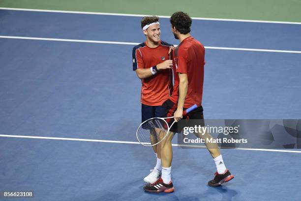 Diego Schwartzman of Argentina celebrates victory with doubles partner Dominic Thiem of Austria in their match against Yuichi Sugita of Japan and...