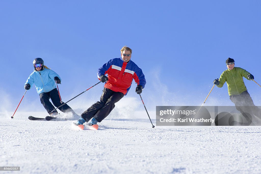 3 people skiing