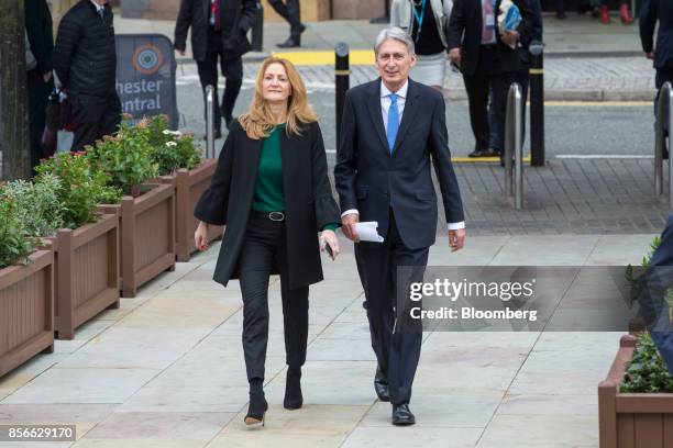 Philip Hammond, U.K. Chancellor of the exchequer, right, and his wife Susan Williams-Walker, arrive at the annual Conservative Party conference in...