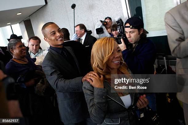 Clifford "T.I." Harris and fiance Tameka Cottle leave the Richard B. Russell Federal Building and United States Courthouse for on March 27, 2009 in...