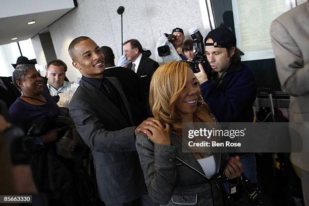 Clifford "T.I." Harris and fiance Tameka Cottle leave the Richard B. Russell Federal Building and United States Courthouse for on March 27, 2009 in...
