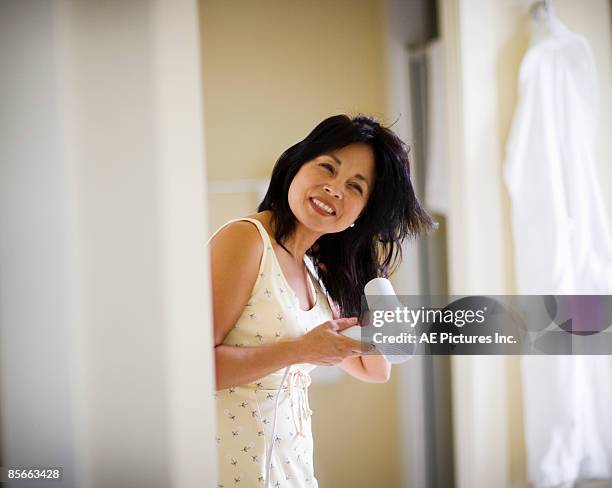 woman blow dries hair - drying hair stock pictures, royalty-free photos & images