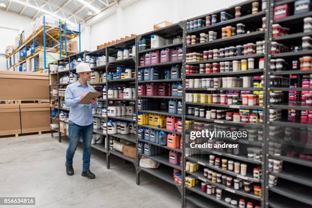 man working at a warehouse doing an inventory - químico imagens e fotografias de stock