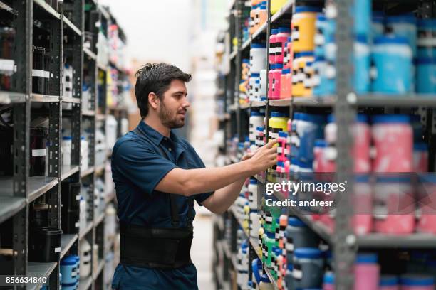 latin american man working at a warehouse - chemical stock pictures, royalty-free photos & images