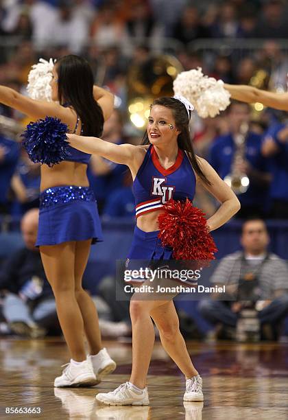 Cheerleader for the Kansas Jayhawks performs against the Dayton Flyers during the second round of the NCAA Division I Men's Basketball Tournament at...