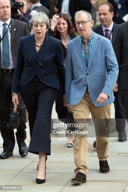 Britain's Prime Minister, Theresa May, and her husband Philip, walk to attend a speech on day two of the Conservative Party Conference at Manchester...