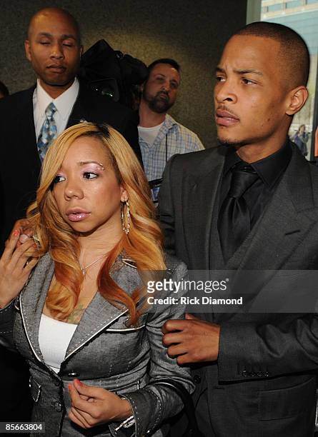 Recording artist Clifford "T.I." Harris and his fiance Tameka Cottle leave a press conference at the Richard B. Russell Federal Building and United...