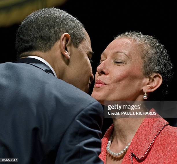 President Barack Obama congratulates Dr. Sharon Malone, wife of US Attorney General Eric H. Holder Jr., after Holder was sworn-in at a installation...