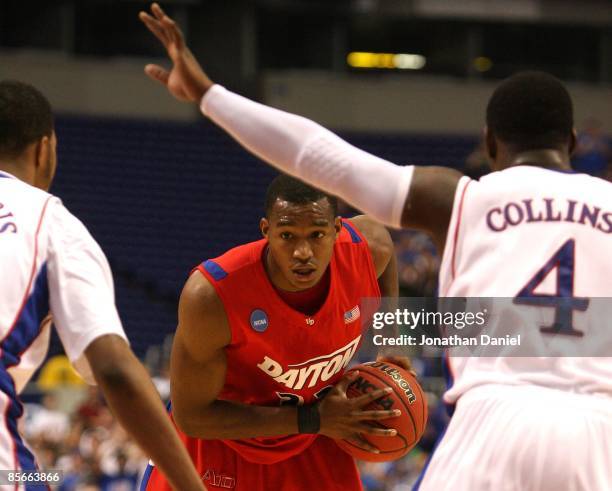 Chris Wright of the Dayton Flyers looks to pass the ball against the Kansas Jayhawks during the second round of the NCAA Division I Men's Basketball...