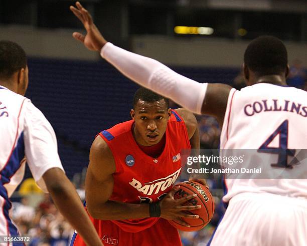 Chris Wright of the Dayton Flyers looks to pass the ball against the Kansas Jayhawks during the second round of the NCAA Division I Men's Basketball...