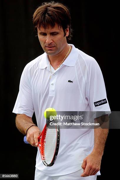 Fabrice Santoro of France balances a ball on his racquet while playing against Nicolas Kiefer of Germany during day five of the Sony Ericsson Open at...