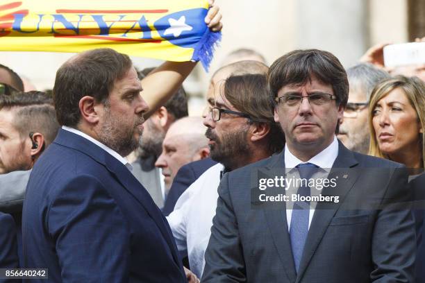 Carles Puigdemont, Catalonia's president, right, and Oriol Junqueras, leader of Esquerra Republicana de Catalunya, join members of the regional...