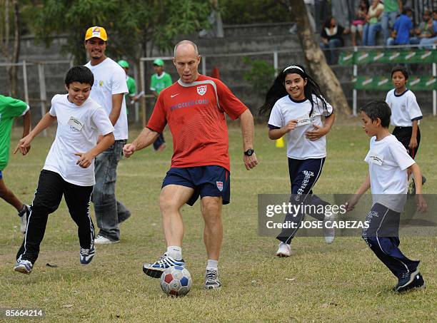 Bob Howard, coach of the United States national football team plays with children in the Don Bosco Institute in Soyapango, a suburb of San Salvador...