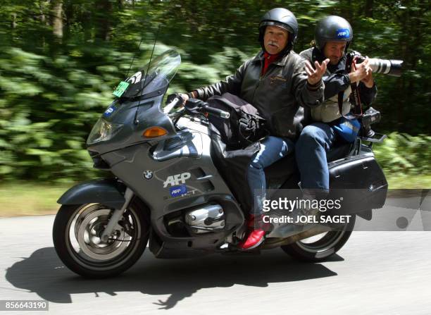 Agence France Presse motorcyclist Georges Stylianos works with Paolo Cocco, an AFP photographer, during the seventh stage of the 91st Tour de France...