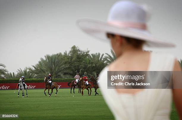 Lady in a hat watches the action during the Cartier International Dubai Polo Challenge at the Desert Palm Hotel on March 27, 2009 in Dubai, United...