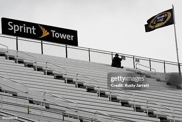 Lone race fan braves the cool wet weather to watch NASCAR Sprint Cup practice during practice for the NASCAR Sprint Cup Series Goody�s Fast Pain...